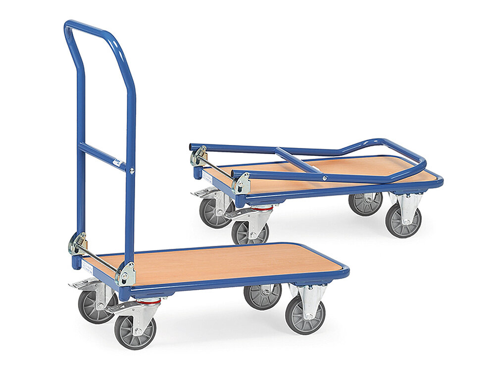 a blue FETRA® collapsible cart made of steel tube with low, rectangular platform of light-coloured wood, blue collapsible push bar, two fixed wheels at the front, two steering wheels at the rear, and a second identical, collapsed cart behind, isolated on white background