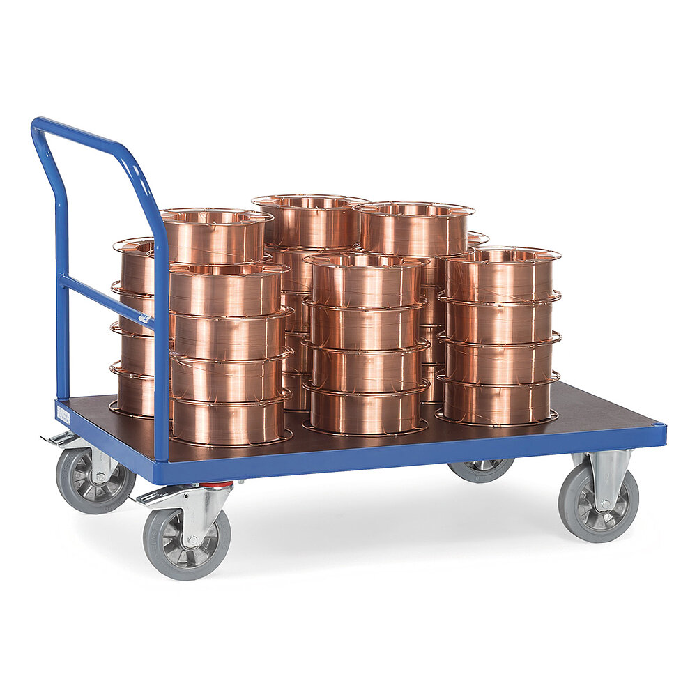 a blue FETRA® heavy duty plattform trolley with push bar, and loaded with a stack of copper wire drums, isolated on white background