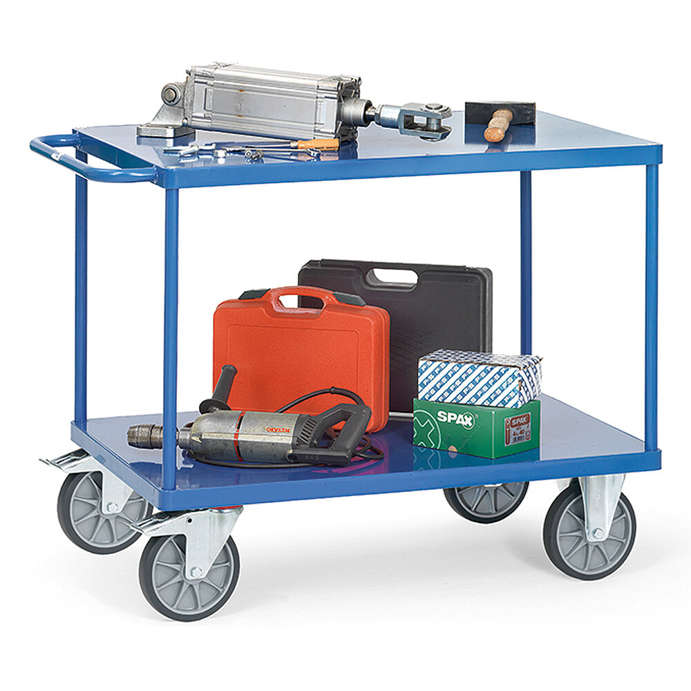 a blue FETRA® table top cart made of steel tubes and profiled steel, with two storeys, push bar, flush-fitting sheet metal platforms, two fixed wheels at the front, two fastenable steering wheels at the rear, and loaded with power tools and a hydraulic cylinder, isolated on white background